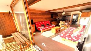 a living room with a red couch and a table at Résidence Saint Roch - Studio pour 4 Personnes 044 in Puy-Saint-Vincent