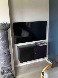 a living room with a large flat screen tv at Spacious house near city centre - WSC 2025! in Trondheim
