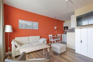 a living room with a couch and a table at Haus Atlantic, FeWo 513 in Döse