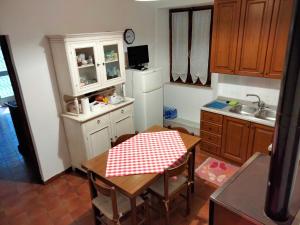 a kitchen with a table with a red and white checkered table cloth at La casa della Nonna in Codiponte