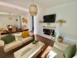 a living room with a couch and a fireplace at Balcón de la Plaza in Moclín