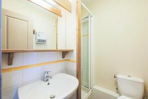 a bathroom with a sink and a toilet and a mirror at Quartier La Forêt - maeva Home - Appartement 2 pièces 6 personnes + coin cabine - Sélection MAE-1634 in Valmorel