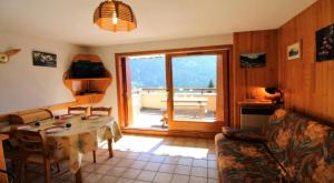 a living room with a table and a couch at Résidence Le Chardonnet - Studio pour 4 Personnes 193282 in Champagny-en-Vanoise