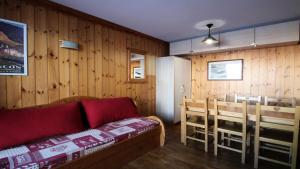 a living room with a couch and a dining room at Résidence Dame Blanche - Chalets pour 6 Personnes 721 in Narreyroux