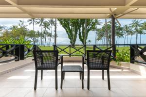 two chairs and a table on a balcony with a view at Shangri-La Tanjung Aru, Kota Kinabalu in Kota Kinabalu