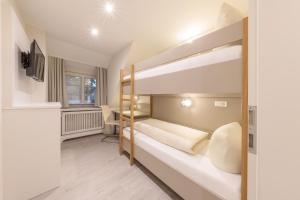 Двухъярусная кровать или двухъярусные кровати в номере Michels Ferienhaus Amalie