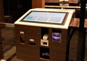 a kiosk with a tablet computer on top of it at APA Hotel Okayama Ekimae in Okayama