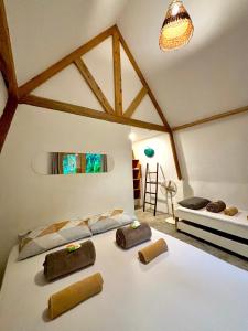 a bedroom with a large white bed in a room at Triangle Palms Siargao in General Luna