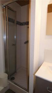 a shower with a glass door in a bathroom at Résidence Terrasse - La Terrasse 11 - Joli appartement, skis aux pieds MAE-5054 in Valmorel