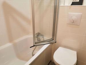 a bathroom with a shower and a toilet and a sink at Résidence Terrasse - La Terrasse 11 - Joli appartement, skis aux pieds MAE-5054 in Valmorel +2 photos