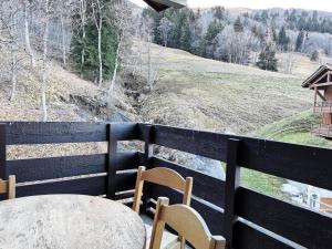 a table and chairs on a balcony with a view at Résidence CLAIRIERE - Studio pour 4 Personnes 04 in Valmorel