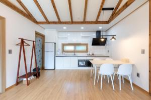 a kitchen and dining room with a table and chairs at Bijarim Healing Pension in Jeju