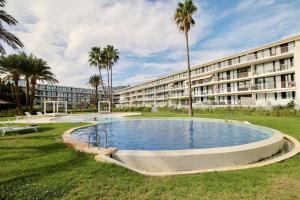 a large building with a large pool in the grass at Denia Beach 40 in Denia