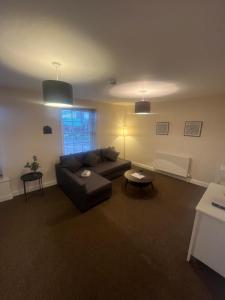 a living room with a couch and a table at Church View Apartment in Great Yarmouth