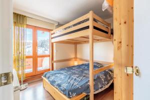 a bedroom with bunk beds in a house at LA MEIJE - Appartement MEIJE 55 pour 6 Personnes 204 in La Plagne Tarentaise
