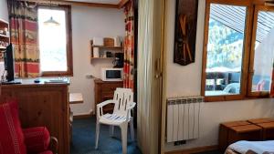 a room with a white chair and a window at Résidence CAILLOU G - Appartement CAILLOU 016 pour 4 Personnes 214 in Les Avanchers