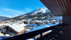 a view from the balcony of a resort with a snow covered mountain at Résidence CAILLOU G - Appartement CAILLOU 016 pour 4 Personnes 214 in Les Avanchers