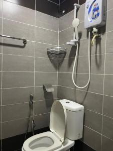a bathroom with a toilet and a shower at Hotel Rim Global Subang in Subang Jaya