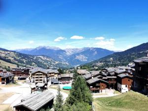 a resort town with mountains in the background at Résidence Terrasse - La Terrasse 25 - Appartement au pied des pistes, magnifique vue MAE-5124 in Valmorel