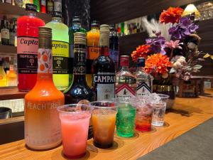 a bunch of different types of drinks on a bar at APA Hotel STAY Toyama in Toyama