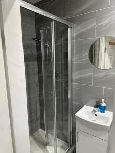 a bathroom with a shower and a toilet and a sink at Guest&rest Ealing 5 in Ealing