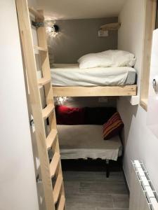 Kleines Zimmer mit Etagenbetten und einem Bett in der Unterkunft Résidence Gentiannes - Appartements pour 5 Personnes 544 in Vars