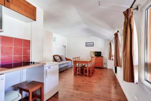 a kitchen and living room with a couch and a table at Les Myrtilles - maeva Home - Appartement 2 pièces 6 personnes - Confort 854 in Vars