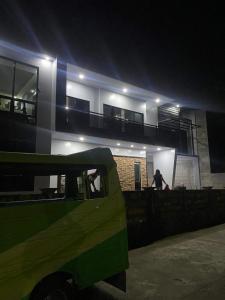 a man standing on the balcony of a house at night at Altavista Resthouse 