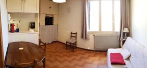 sala de estar con mesa y cocina en Résidence Centre Vars - Studio pour 3 Personnes 914, en Vars