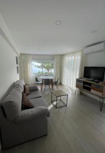 a living room with a couch and a table at Edificio Albires in Albir