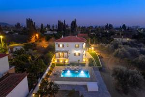 an aerial view of a house with a swimming pool at Kostis Orange Resort in Volos