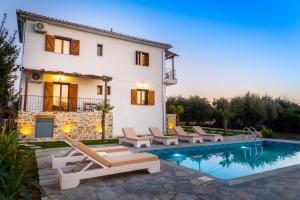 a villa with a swimming pool and a house at Kostis Orange Resort in Volos