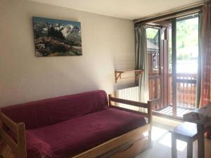 a living room with a couch and a window at Résidence Andromede - Studio pour 4 Personnes 384 in Vénosc