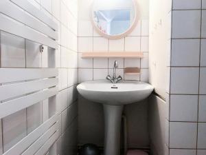 a white bathroom with a sink and a mirror at Résidence Andromede - Studio pour 4 Personnes 384 in Vénosc