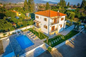 an aerial view of a house with a swimming pool at Kostis Orange Resort in Volos