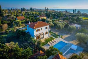 an aerial view of a house with a swimming pool at Kostis Orange Resort in Volos