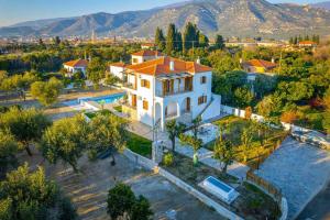 an aerial view of a white house with a pool at Kostis Orange Resort in Volos