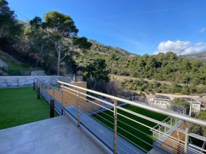 a balcony with a view of the mountains at Luxury Blue Paradise Alassio in Alassio