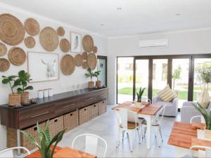 a kitchen and living room with a table and chairs at Maxton Boutique Hotel Upington in Upington
