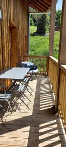 a patio with a table and chairs on a deck at Résidence LUMI BATIMENT B - Appartement LUMI B 834 in Valmorel
