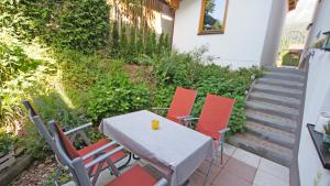 a table and four chairs on a patio at Landhaus Kaiserbach in Ellmau