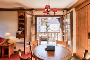 a dining room with a table and a large window at Résidence Les Arcs Le Village - maeva Home - Appartement pièces - Prestige 204 in Bourg-Saint-Maurice
