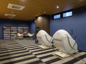 two toilets in a room with blue walls at APA Hotel STAY Toyama in Toyama