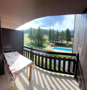 a balcony of a house with a view of a pool at Résidence Florins - 2 Pièces pour 4 Personnes 404 in Risoul