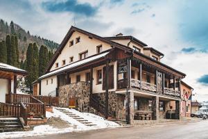 a large building with snow in front of it at U GORAĽA in Lesnica