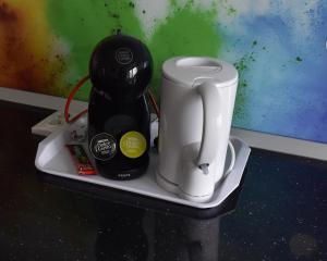 a counter with a coffee maker and a blender on it at Mall Apartment 100mp in Bacău