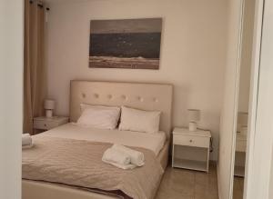 a bedroom with a bed with two night stands and two lamps at Lion Apartment in Limenas