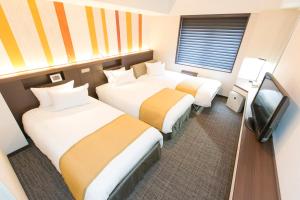 Postel nebo postele na pokoji v ubytování Shinagawa Tobu Hotel