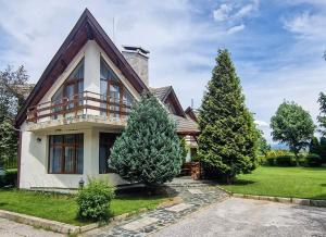 a house with two trees in front of it at Villa Deja Vu in Razlog