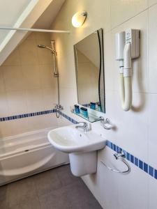 a bathroom with a sink and a mirror and a tub at Chalet Deja Vu in Razlog